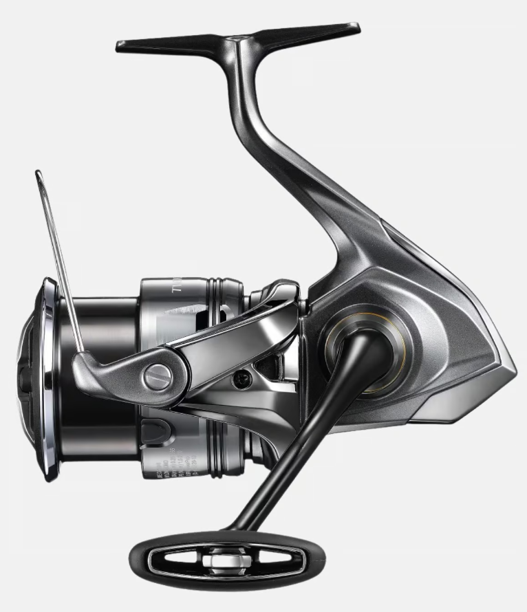 shimano-twin-power-fe-400m - freddiethepillowandfriends.co.uk Close-up of a modern spinning fishing reel with handle and spool visible, ready for use on a rod.