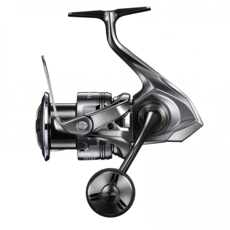 shimano-twin-power-pg - freddiethepillowandfriends.co.uk Side view of a silver spinning fishing reel with handle, spool, and bail arm visible